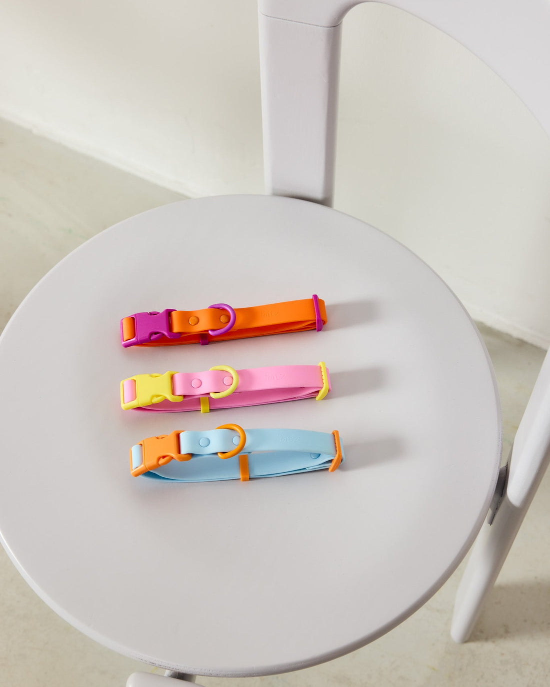 Three Fritz collars laid out on a chair