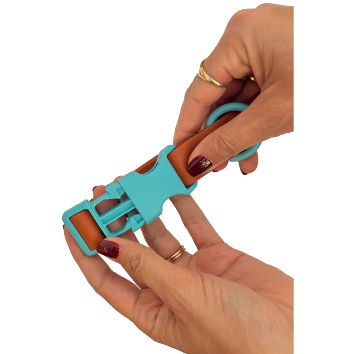 The Choco Blue collar buckle opened between two hands